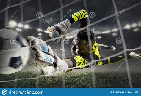 African Male Soccer Or Football Player Goalkeeper In Action At Stadium