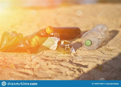 Pollution Of Plastic Beach Bottles Empty Used Dirty Bottles And Cans Dirty Sandy Beach