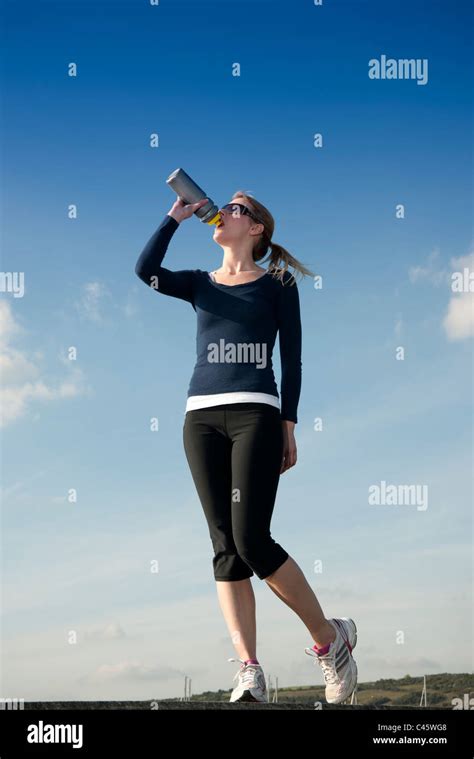 Woman Drinking Water After Exercising Stock Photo Alamy