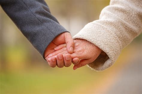 Close Up Of Senior Couple Holding Hands Free Photo