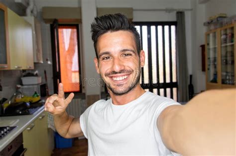 Handsome Caucasian Man Taking A Selfie Portrait Indoor At Home Happy