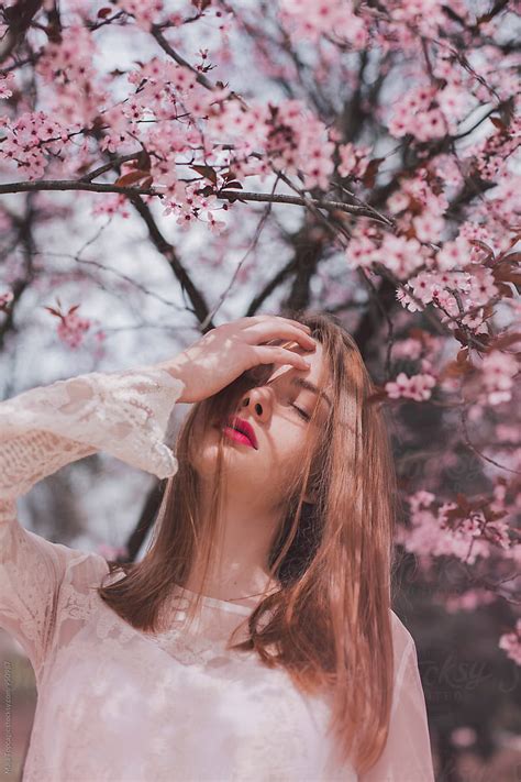Portrait Of A Freckled Woman In Pink Blossom Tree By Stocksy Contributor Maja Topcagic Stocksy