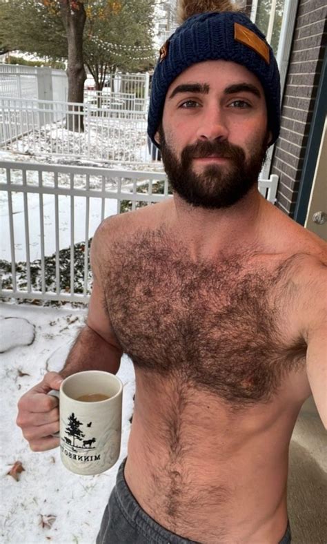 A Shirtless Man Holding A Coffee Mug In The Snow