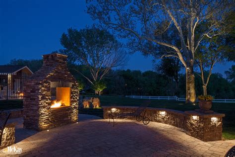 Inexpensive rope lighting creates a great uplighting effect when placed on the back of landscape bed edging. Patio Seat Wall Lighting to Transform Your Fire Pit Experience