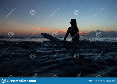 Beautiful Girl With A Surfboard At Sunset Stock Photo Image Of Bali