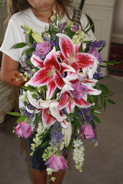 Stargazer lily and rose cascading bouquet. | Stargazer ... They grow on tall skinny stocks with long pointy leaves.