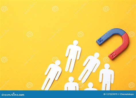 magnet attracting people traffic on color background top view with space for text stock image