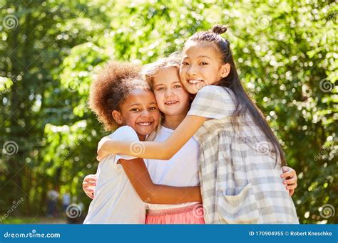 Three Multicultural Girls Hug Each Other Stock Image Image Of