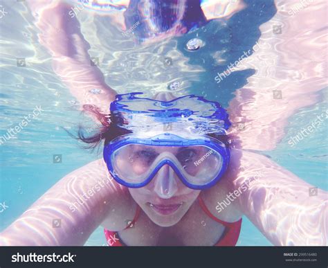 Woman Wearing Red Top Bikini And Diving Mask Taking Underwater Self