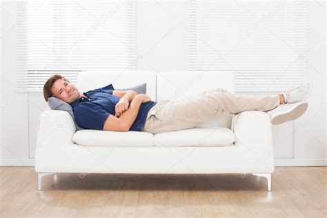 Man Lying On Sofa At Home Stock Photo By ©andreypopov 71491863