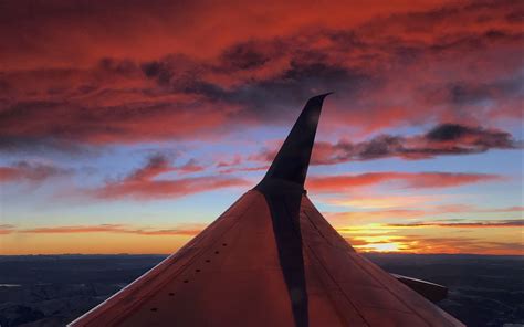 Download Wallpaper 1440x900 Airplane Wing Clouds Sky Sunset
