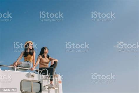 Asian Chinese Lesbian Couple Enjoying Scenic View On Top Of Campervan