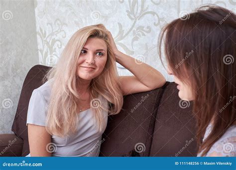 Two Women Friends Chatting On The Couch At Home Stock Photo Image Of