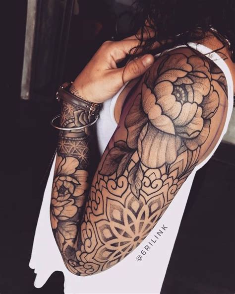 A Woman With Tattoos On Her Arms And Arm