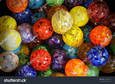 Blown Glass Balls Multi Colored And Arranged In A Pile With Darkened Photo Edges Multi