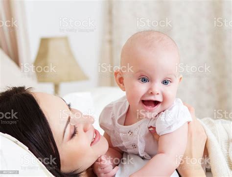Happy Smiling Mother With Six Month Old Baby Girl Stock Photo