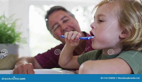 Caucasian Grandfather Helping His Grandson To Brush His Teeth At Home Stock Footage Video Of