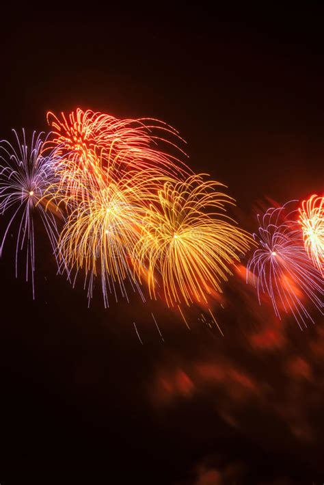 Red Yellow And Blue Fireworks Against A Black Sky Stock Photo Image