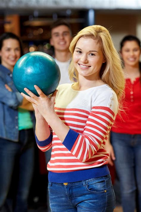 Happy Young Woman Holding Ball In Bowling Club Stock Photo Image Of