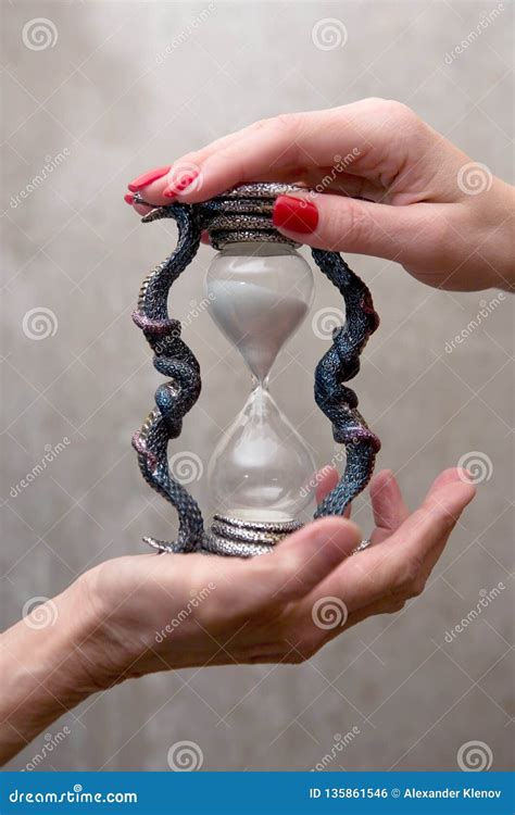 Hands Of A Young And Old Woman Holding An Hourglass Stock Photo Image
