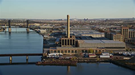 55k Stock Footage Aerial Video Of Riverfront Factory At Sunrise In