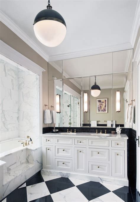 Classic Bathroom With Checked Floor And Brass Fixtures Mirrored Wall
