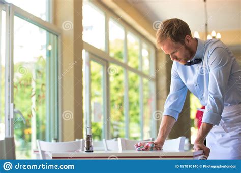 Waiter Cleaning The Table At Restaurant Stock Photo Image Of