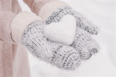 Hotel St Moritz Hands In Woolen Mittens Holding Heart Shaped Snow