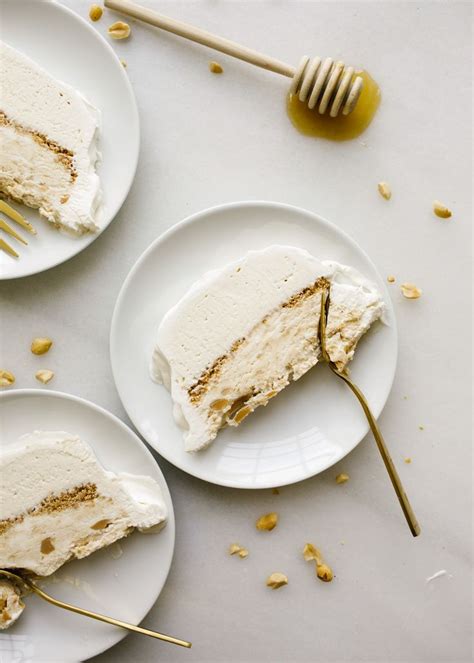 Three Slices Of Cake On White Plates With Gold Forks And Spoons Next To
