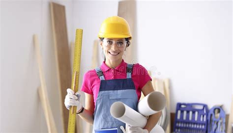 Woman Architect Holding Ruler And Paper In Workshop Stock Photo Image