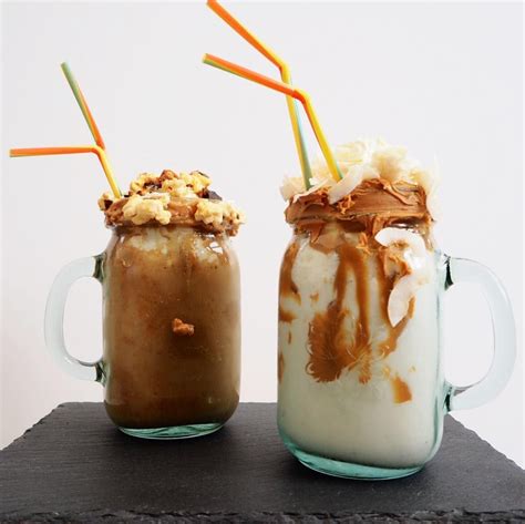 Two Mason Jars Filled With Ice Cream And Caramel