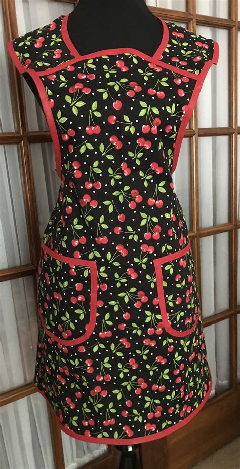 this polka dot cherry print give a modern flair to a vintage style our cherries apron is a