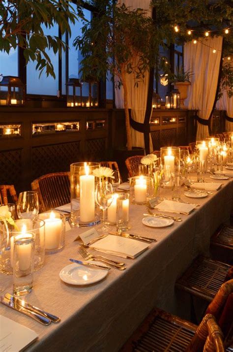 Small votives in lanterns line the perimeter while pillar candles