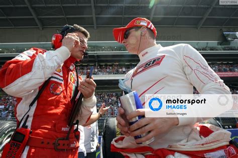 Kimi Raikkonen Fin Ferrari Talks With Chris Dyer Gbr On The Grid