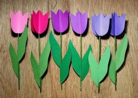 Paper Tulips Are Lined Up On A Table With Green Leaves And Purple Ones