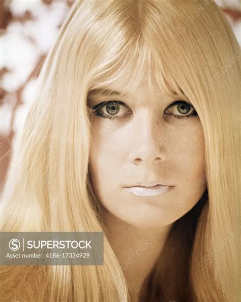 1960s 1970s woman long blonde hair bangs pale pink lipstick dark eye makeup sexy facial