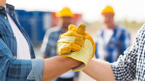 Close Up Of Builders Hands Making Handshake