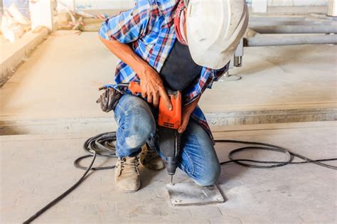 Premium Photo Construction Worker Using Electric Drill To Install