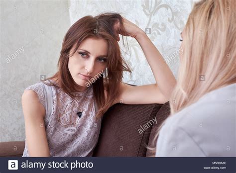 Sad Woman Has Problem Other Woman Consoling Her At Sofa In Home Stock