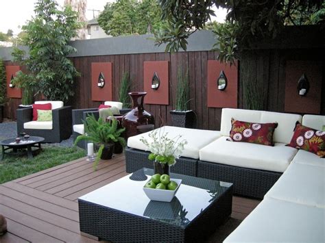 An Outdoor Living Area With Couches Tables And Plants On The Deck In
