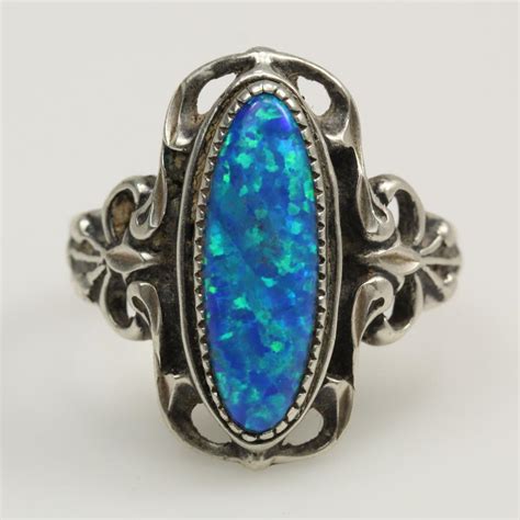 The center stones are emerald step cut and prong set. Sterling Silver 5.8g Ring With Blue Iridescent Stone ...