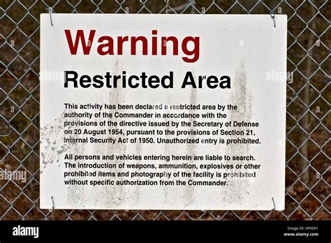 A Restricted Area Sign On The Outside Of A Us Army Installation Fence