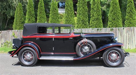Red with black interior and wearing an older restoration. Cruise In Grandeur With This Restored 1931 Auburn 8-98 Phaeton