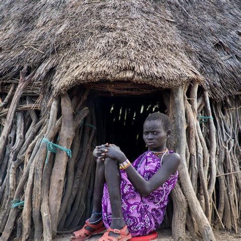 Toposa Tribe Woman Sit At The Entrance Of Her Hut Namorunyang State