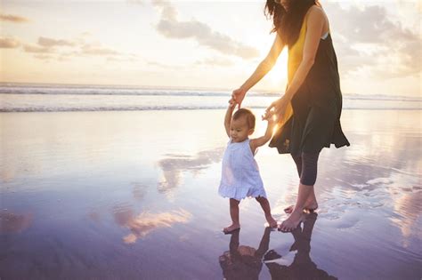 Madre Enseña A Su Hija A Caminar Por La Playa Foto Premium