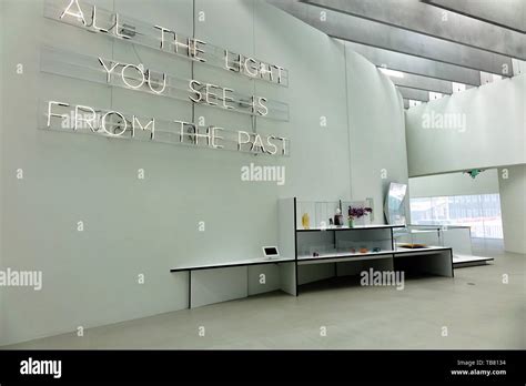 Gallery in the Corning Museum of Glass. The fluorescent lit sign says