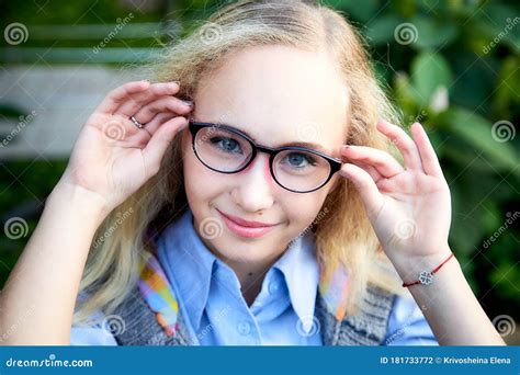 Pretty Teenage Girl 14 16 Year Old With Curly Long Blonde Hair And In Glasses In The Green Park