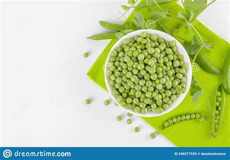 Fresh Green Peas In A Bowl With Peas Plants Leaves On A Napkin On White