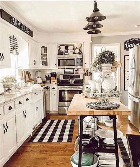 Choosing a mostly white kitchen with touches of black is the safest choice, while black cabinetry matched with white countertops is a braver option that can look smart, dramatic and always neat. Love the white cabinets, and black hardware. | Kitchen ...