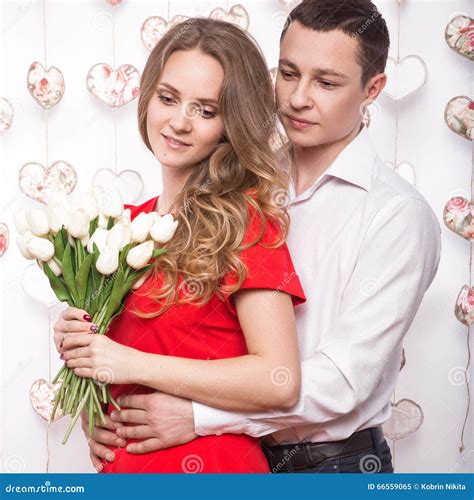 Beautiful Young Couple In Love With A Bouquet Of Flowers Valentine S